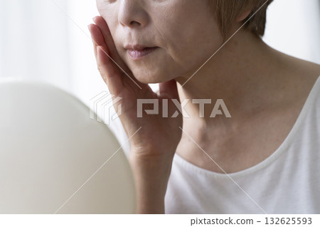 Senior woman worried about facial aging 132625593