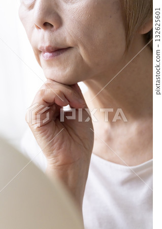 Senior woman worried about facial aging 132625601