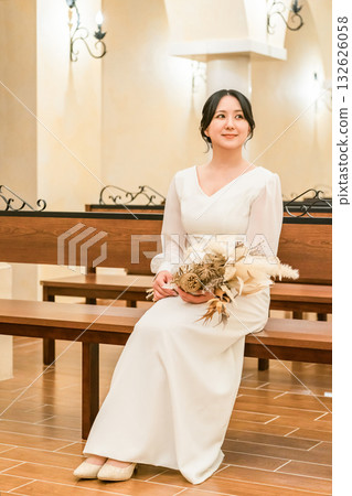 Wedding hall, bride sitting on a bench in the chapel, bride (aisin road, church, chapel) Wedding hall, bride sitting on a bench in the chapel, bride (aisin road, church, chapel) 132626058