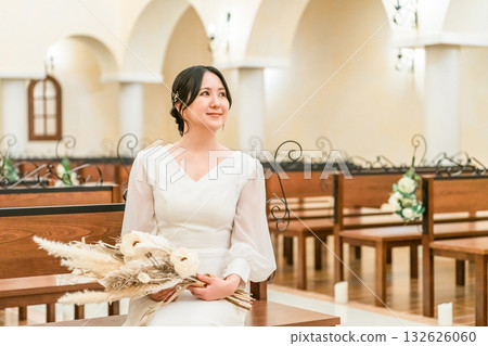Wedding hall, bride sitting on a bench in the chapel, bride (aisin road, church, chapel) Wedding hall, bride sitting on a bench in the chapel, bride (aisin road, church, chapel) 132626060