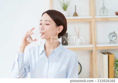 A woman drinking water 132626168