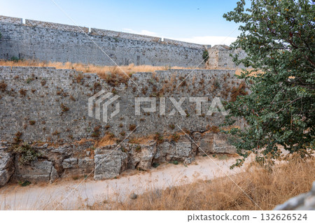 Stone powerful walls of old city, the ancient defense of Old Town, Rhodes, Dodecanese, Greece. High quality photo Stone powerful walls of old city, the ancient defense of Old Town, Rhodes, Dodecanese, Greece. High quality photo 132626524