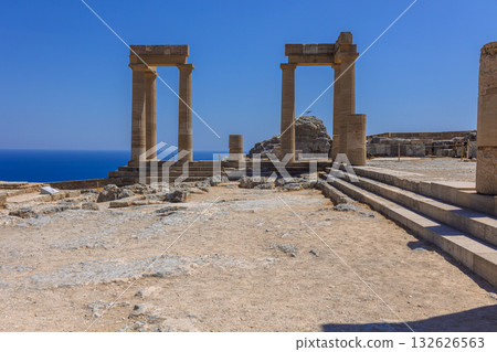 Panoramic view of ruins of ancient city of Lindos on colorful island of Rhodes, Greece. Famous tourist attraction. Ancient temple Greek architecture. High quality photo 132626563