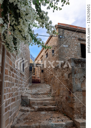 Street view of old town of Rhodes, Greece. Paved roads and pavements with colorful houses and fragrant flowers. High quality photo 132626601