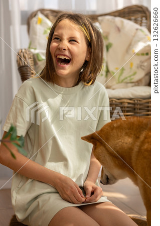 Portrait of little girl playing with her dog husky on sunny day. High quality photo 132626660