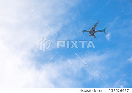 View of airplane flying in blue sky among white clouds. . High quality photo 132626687