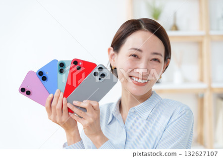 A woman with multiple smartphones A woman with multiple smartphones 132627107
