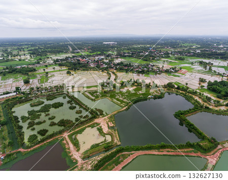 The aerial view of many ponds and paths near the manufactory shot by drone. The aerial view of many ponds and paths near the manufactory shot by drone. 132627130