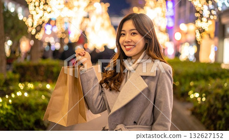 A woman holding a paper bag and illuminations 132627152