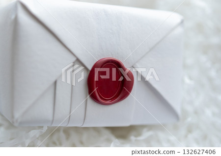 Wax seal stamp on white paper wrap packaging parcel box Wax seal stamp on white paper wrap packaging parcel box 132627406