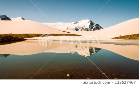 Snowy Mountain Reflected on Calm Lake Under Clear Blue Sky 132627467