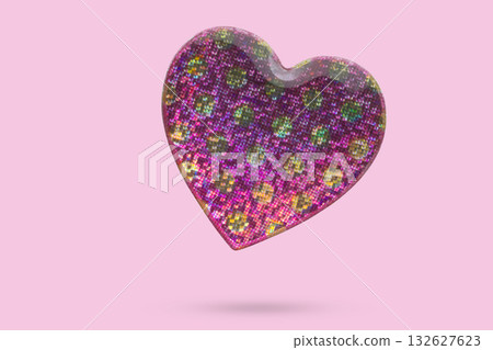 Pink heart shape hologram sticker flying on pink background Pink heart shape hologram sticker flying on pink background 132627623