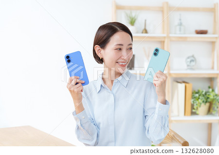 A woman with multiple smartphones A woman with multiple smartphones 132628080