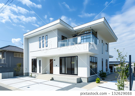 The exterior of a modern house that stands out against the blue sky (a modern building with a white base) The exterior of a modern house that stands out against the blue sky (a modern building with a white base) 132629088
