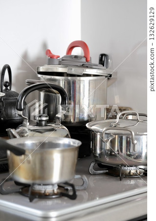 Dirty stainless steel cookware placed in a mess 132629129