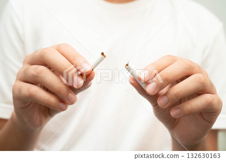 Quit smoking, Asian teenage man breaking destroy cigarette in hand. 132630163