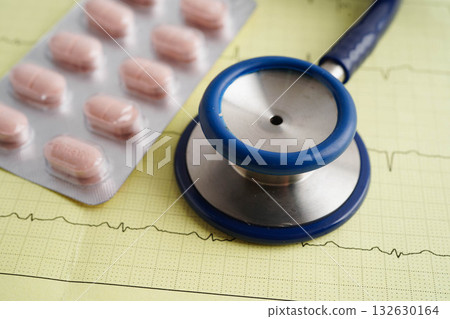 Stethoscope on electrocardiogram ECG with capsule drug, heart wave, heart attack, cardiogram report. Stethoscope on electrocardiogram ECG with capsule drug, heart wave, heart attack, cardiogram report. 132630164
