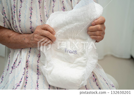 Asian senior woman patient wearing adult incontinence diaper pad in hospital. 132630201