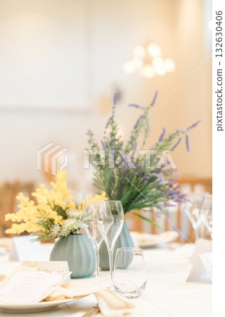 Floral decorations on tables at a wedding reception Floral decorations on tables at a wedding reception 132630406