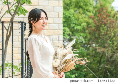 Wedding venue, dried flowers in the chapel, bride in a dress holding a swag, bride 132631188