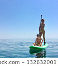 Sup board. water sport. a young man stands on a board in the sea 132632001
