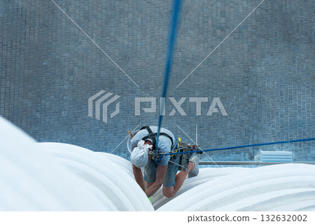 high-altitude climber. The profession of working at height. high-altitude climber. The profession of working at height. 132632002