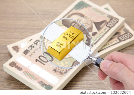 放在一疊鈔票上的金錠的特寫 132632604