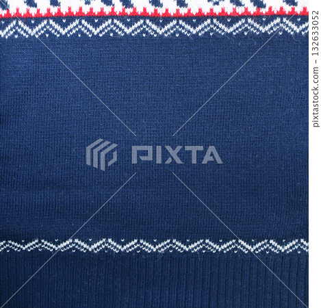 Horizontal or vertical Christmas background with knitted fabric texture. Wool sweater texture of dark blue color with white border. Natural knitted wool indigo color material with white ornament Horizontal or vertical Christmas background with knitted fabric texture. Wool sweater texture of dark blue color with white border. Natural knitted wool indigo color material with white ornament 132633052