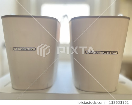 Two laundry baskets lined up in a bright room, expressing ideas for living and a sense of cleanliness. Two laundry baskets lined up in a bright room, expressing ideas for living and a sense of cleanliness. 132633561