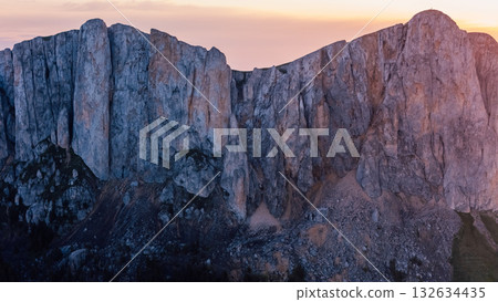 Drone view of Bolshoy Tkhach mountain rocks in Caucasus with sunset or sunrise tones 132634435