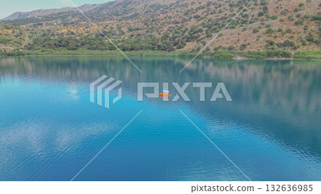 Family riding pedal boat on freshwater Kournas Lake near Georgioupoli in Crete. Family riding pedal boat on freshwater Kournas Lake near Georgioupoli in Crete. 132636985