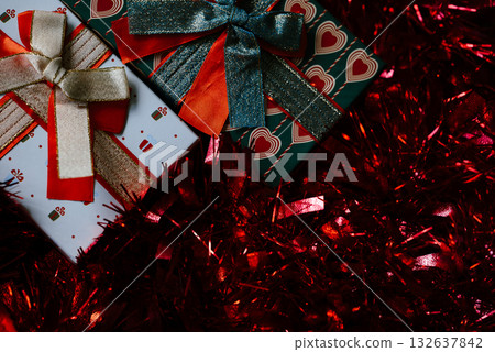 Festive Gift Boxes with Sparkling Red Tinsel Festive Gift Boxes with Sparkling Red Tinsel 132637842