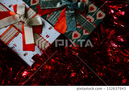 Festive Gift Boxes with Sparkling Red Tinsel Festive Gift Boxes with Sparkling Red Tinsel 132637843