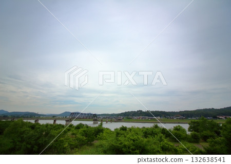 A view of spreading thin clouds and a river A view of spreading thin clouds and a river 132638541