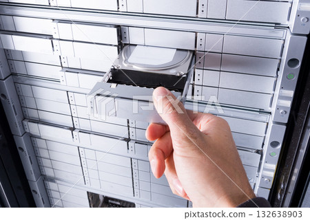 hand of IT technician installing hard drive with SAS interface i 132638903