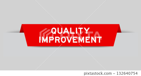 Red color inserted label with word quality improvement on gray background 132640754