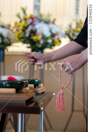 The hands of a woman offering incense at a funeral 132640816