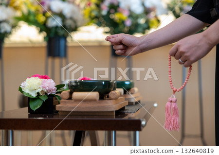 The hands of a woman offering incense at a funeral The hands of a woman offering incense at a funeral 132640819