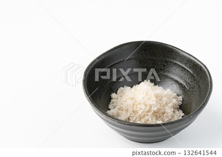 Moshio seaweed salt in a small bowl on a white background Moshio seaweed salt in a small bowl on a white background 132641544