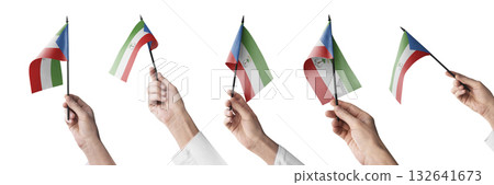 The Equatorial Guinea flag in hand in different angles on a white background 132641673