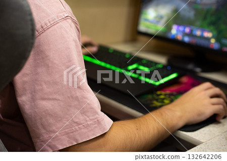 Gamer hands on modern backlit keyboard and mouse. Concept of gaming industry and computer gaming devices. Mechanical gaming keyboard on gamer desk at home Gamer hands on modern backlit keyboard and mouse. Concept of gaming industry and computer gaming devices. Mechanical gaming keyboard on gamer desk at home 132642206