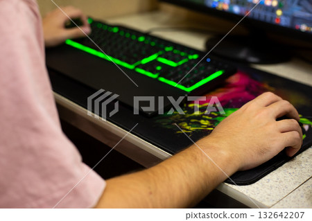 Gamer hand on mouse, other hand on keyboard. Professional hand position of video game player on modern backlit mechanical keyboard. Concept from the video game industry 132642207