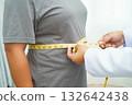 Asian woman with fat belly big size overweight and obesity with measure tape. 132642438