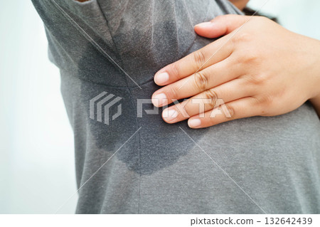 Sweaty underarms, Asian woman with sweat on clothes under armpit. 132642439