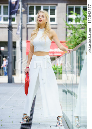 Woman wearing crop top and culottes Woman wearing crop top and culottes 132642477