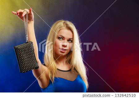 Elegant woman holds black handbag 132642510