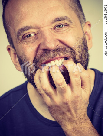 Man biting his nails 132642601