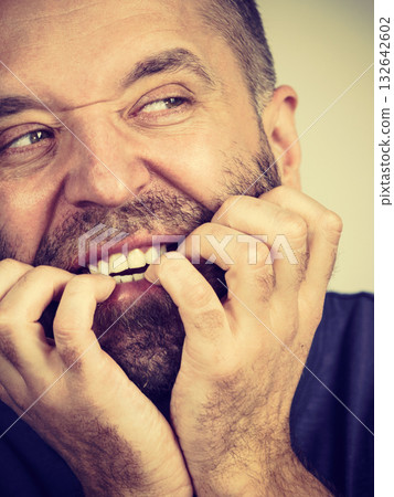 Man biting his nails 132642602