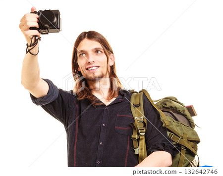 Man tourist backpacker taking photo with camera. 132642746