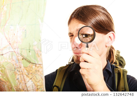 Man tourist reading map with magnifying glass 132642748